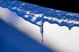 Macro photography of ice bubbles under the lights against a dark blurry background